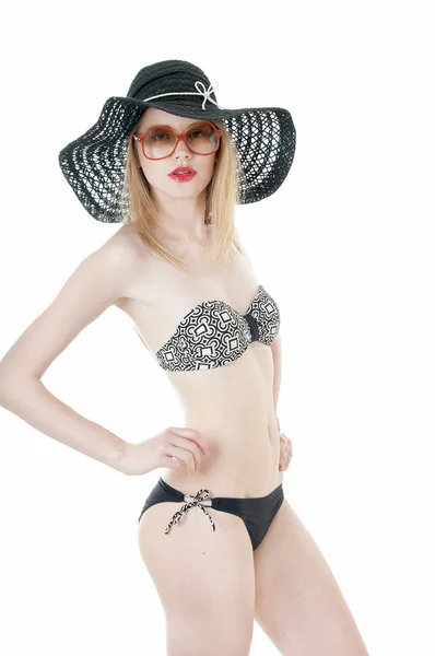 Stylish girl in a bikini  wearing a summer hat and retro sunglasses — Zdjęcie stockowe