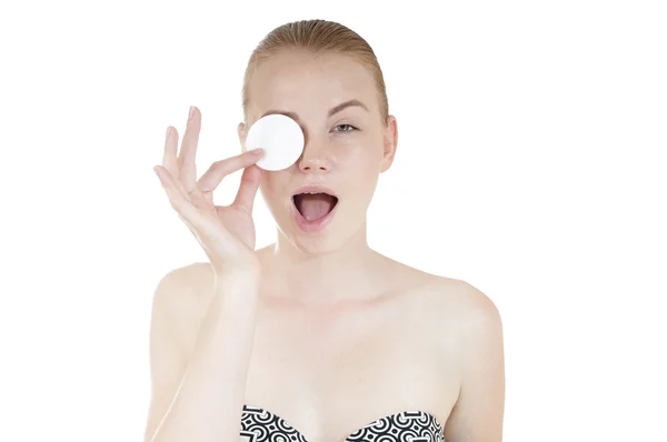 Close-up portrait of young funny girl with cotton swab cleaning her face — Stockfoto