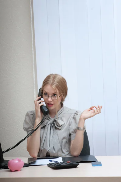 Emotionally business woman on landline phone call — Stock Photo, Image