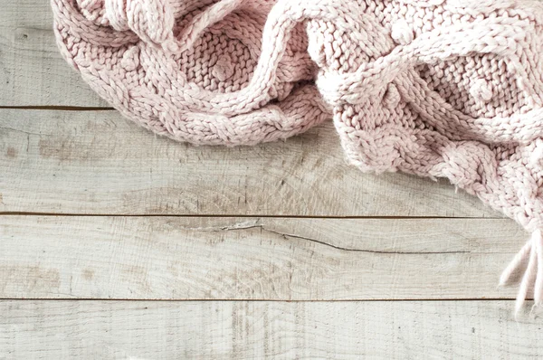 Pink knitted scarf on wooden board with copy space for text. — Stock Photo, Image