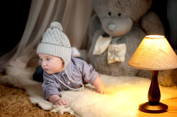 Cute happy baby boy portrait lying on fur — Stock Photo, Image