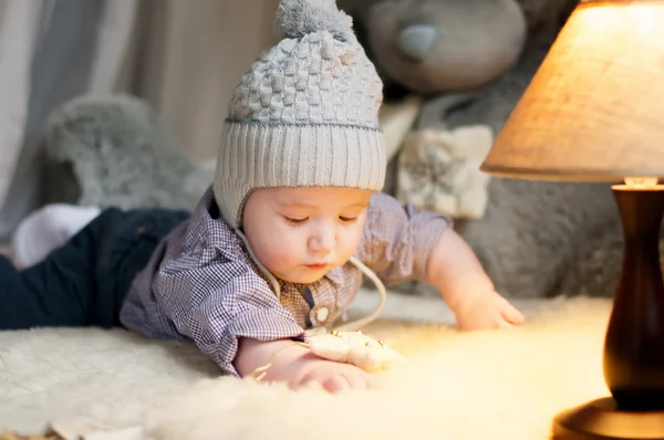 Cute happy baby boy portrait lying on fur — Stock Photo, Image