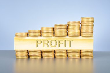 Ahşap üzerine yazılmış kelime ile altın sikke yığını