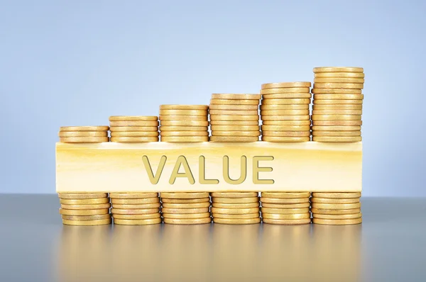 Stack of golden coin with word written on wood — Stock Photo, Image