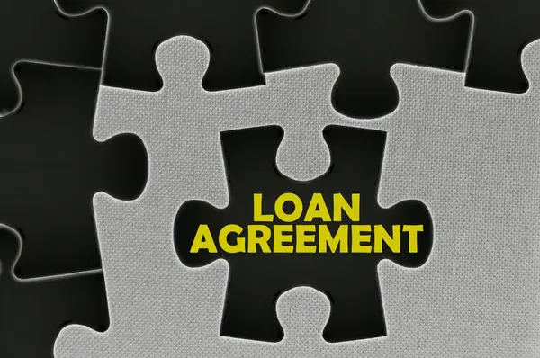 The white jigsaw puzzle written word loan agreement — Stock Photo, Image