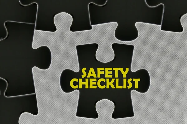 The white jigsaw puzzle written word safety checklist — Stock Photo, Image