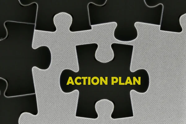 The black jigsaw puzzle written word action plan — Stock Photo, Image