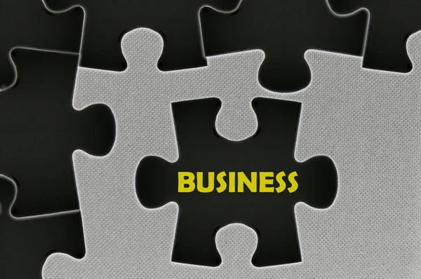 The black jigsaw puzzle written word business — Stock Photo, Image