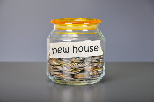 Saving concept of coins in the glass jar for new house  purpose