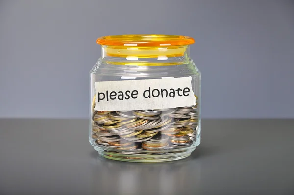 Saving concept of coins in the glass jar for please donate  purp — Stock Photo, Image