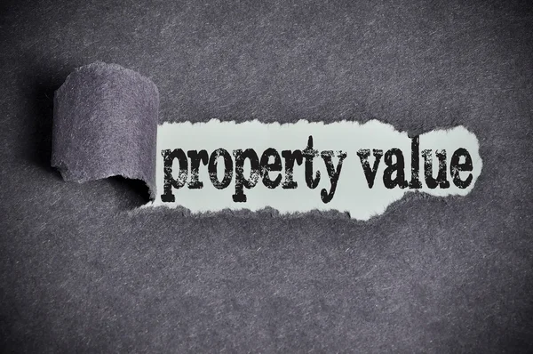 Property value word under torn black sugar paper — Stock Photo, Image