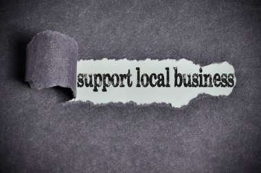 support local business word under torn black sugar paper  clipart