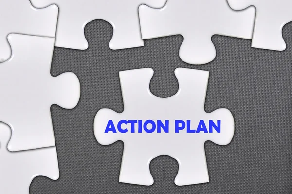 Jigsaw puzzle written word action plan — Stock Photo, Image