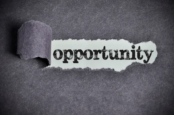 Opportunity word under torn black sugar paper — Stock Photo, Image