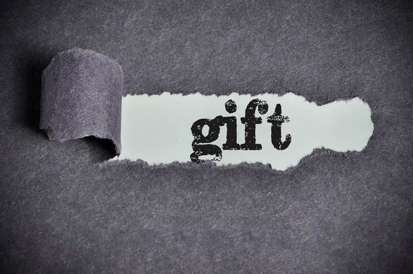 Gift word under torn black sugar paper — Stock Photo, Image