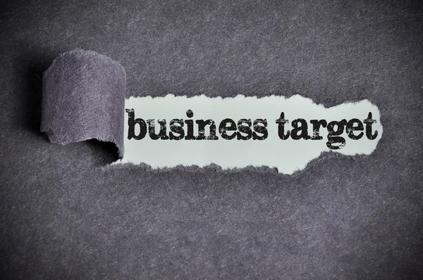 Business target word under torn black sugar paper — Stock Photo, Image