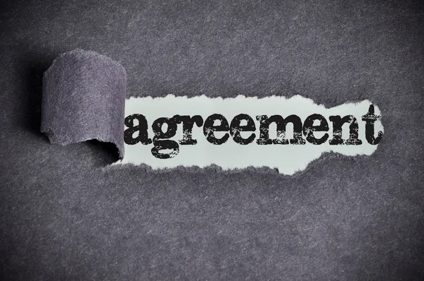 Agreement word under torn black sugar paper — Stock Photo, Image