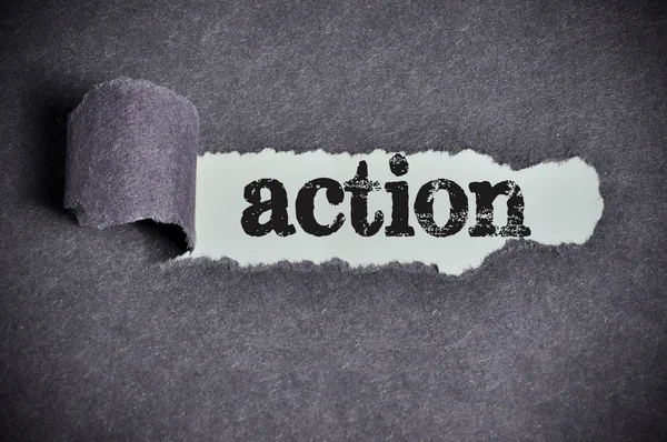 Action word under torn black sugar paper — Stock Photo, Image
