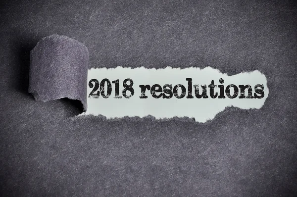 2018 resolutions word under torn black sugar paper — Stock Photo, Image