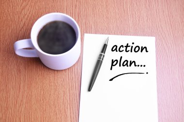 Coffee, pen and notes write action plan