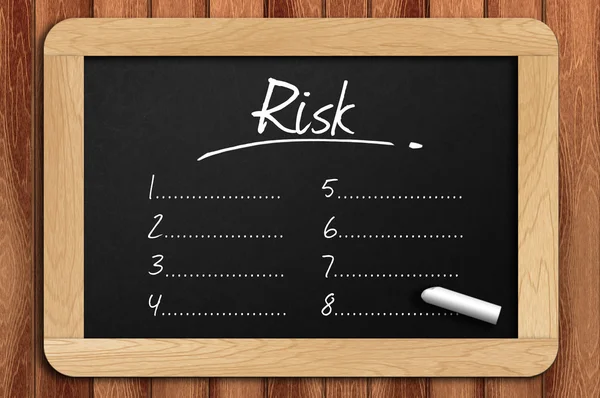 Chalkboard on the wooden table written risk list — Stock Photo, Image