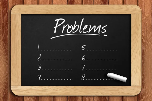 Schoolbord op de houten tafel geschreven problemen lijst — Stockfoto