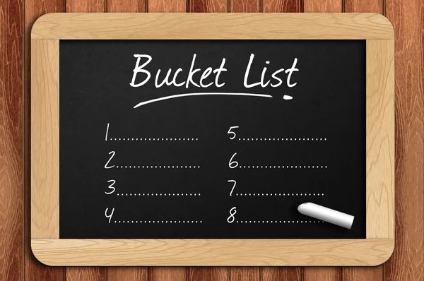 Chalkboard on the wooden table written bucket list — Stock Photo, Image