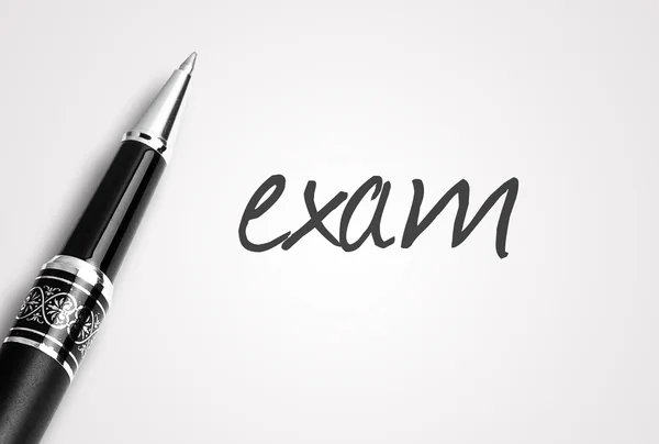 Pen writes exam on paper — Stock Photo, Image