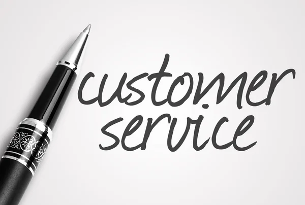 Pen writes customer service  on paper — Stock Photo, Image