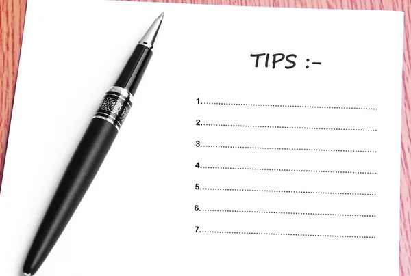 Pen  and notes paper with tips list — Stock Photo, Image