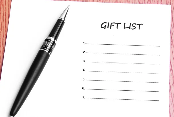 Pen  and notes paper with gift list — Stock Photo, Image