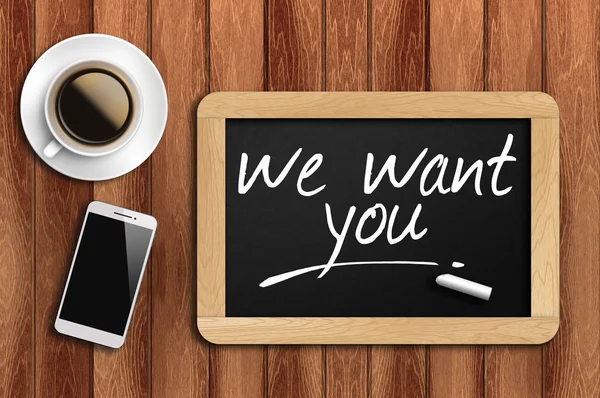 Coffee, phone and chalkboard with we want you words — Stock Photo, Image