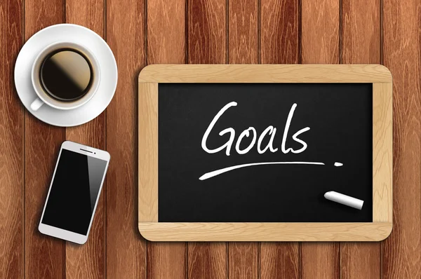 Coffee, phone  and chalkboard with  word goals — Stock Photo, Image