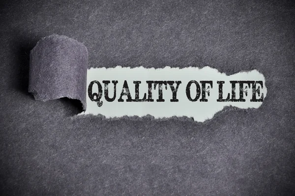 Quality of life word under torn black sugar paper — Stock Photo, Image