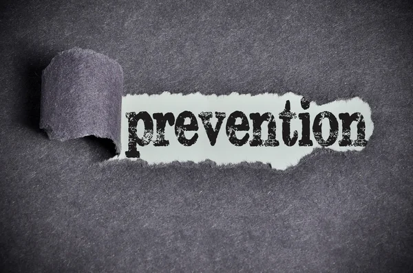 Prevention word under torn black sugar paper — Stock Photo, Image