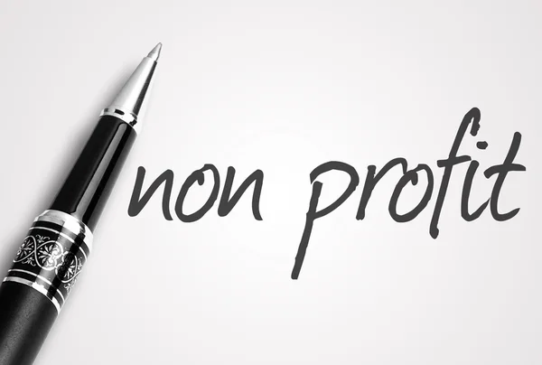 Pen schrijft non-profit op witte blanco papier — Stockfoto
