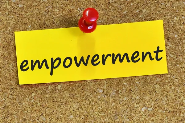 Empowerment woord op gele postpapier met kurk achtergrond — Stockfoto