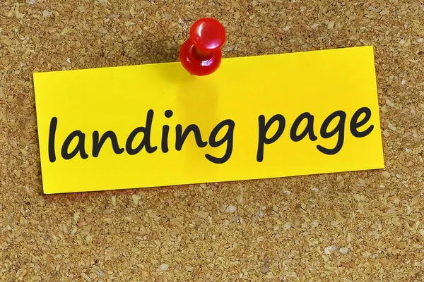 Landing page word on yellow notepaper with cork background — Stock Photo, Image