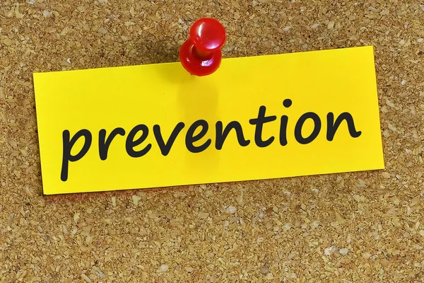 Prevention word on yellow notepaper with cork background — Stock Photo, Image