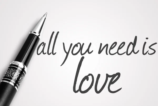 Pluma escribe todo lo que necesitas es amor en blanco papel en blanco — Foto de Stock