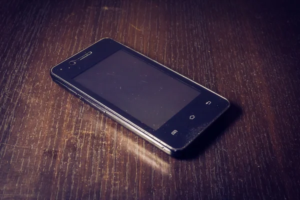 Smartphone a wooden table — Stock Photo, Image