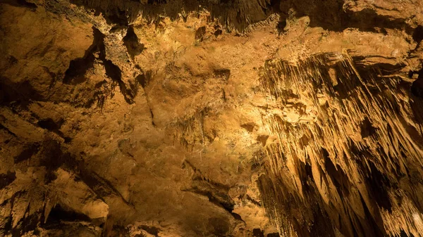 Cave rock walls scene view. Magic light into cave