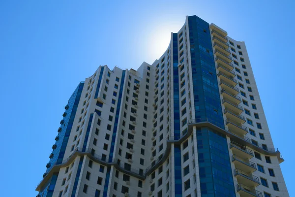 High-rise apartment building in front of the sunny sky