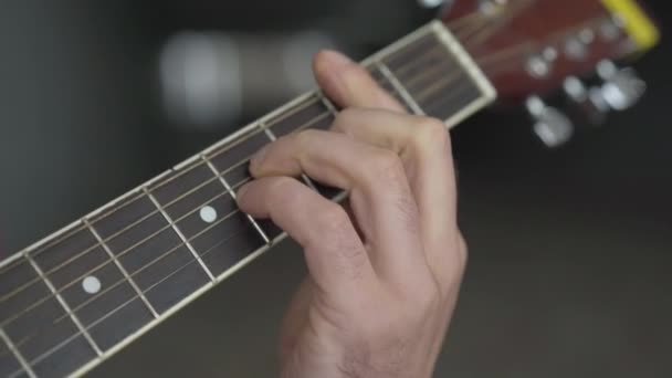 Mężczyzna kaukaski ręka na gitarze podstrunnicy zbliżenie. Nierozpoznawalny muzyk grający na instrumencie muzycznym. Koncepcja sztuki i performance. — Wideo stockowe