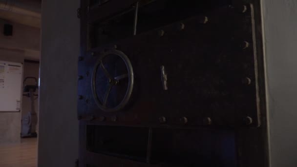 Massive metal door with round wheel. Huge safe storage or bank vault. — Stock Video