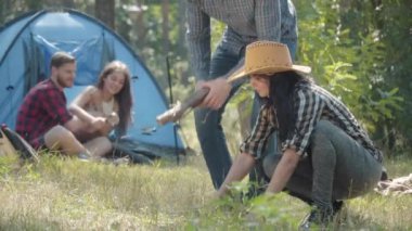 Şapkalı genç adam yakacak odun getiriyor ve büyüleyici bir kadınla konuşuyor bulanık arkadaşlar gibi büyüteçle bir şeyi inceliyorlar. Yürüyüş sırasında kamp yapan bir grup turist..