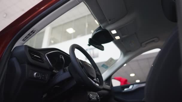 Zijaanzicht luxe auto interieurs in dealerovereenkomst binnen. Dure auto in de auto showroom. Automobielindustrie en consumentenbeleid. — Stockvideo