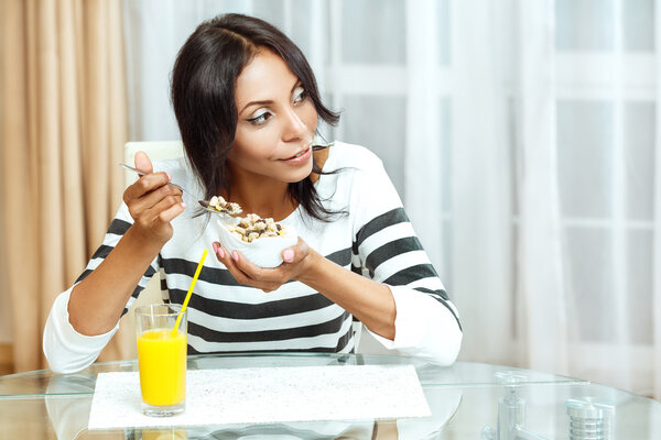 Portrait of woman eating cereals. 