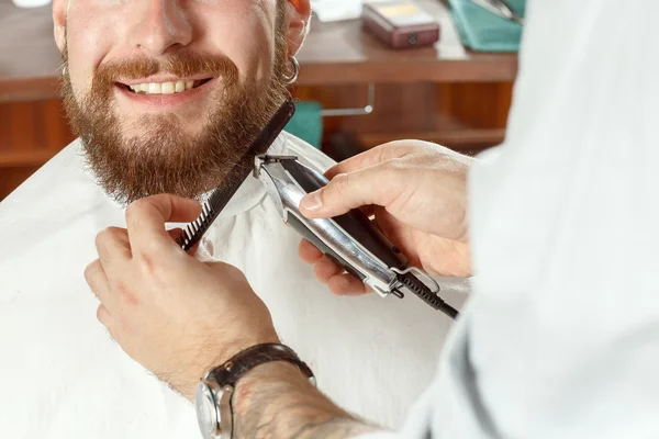 The portrait of a smiling hipster during the shave — Stock Photo, Image
