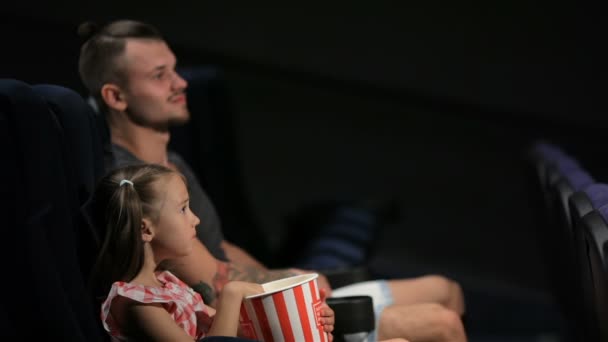 Elder brother and little sister are watching movie — Stock Video